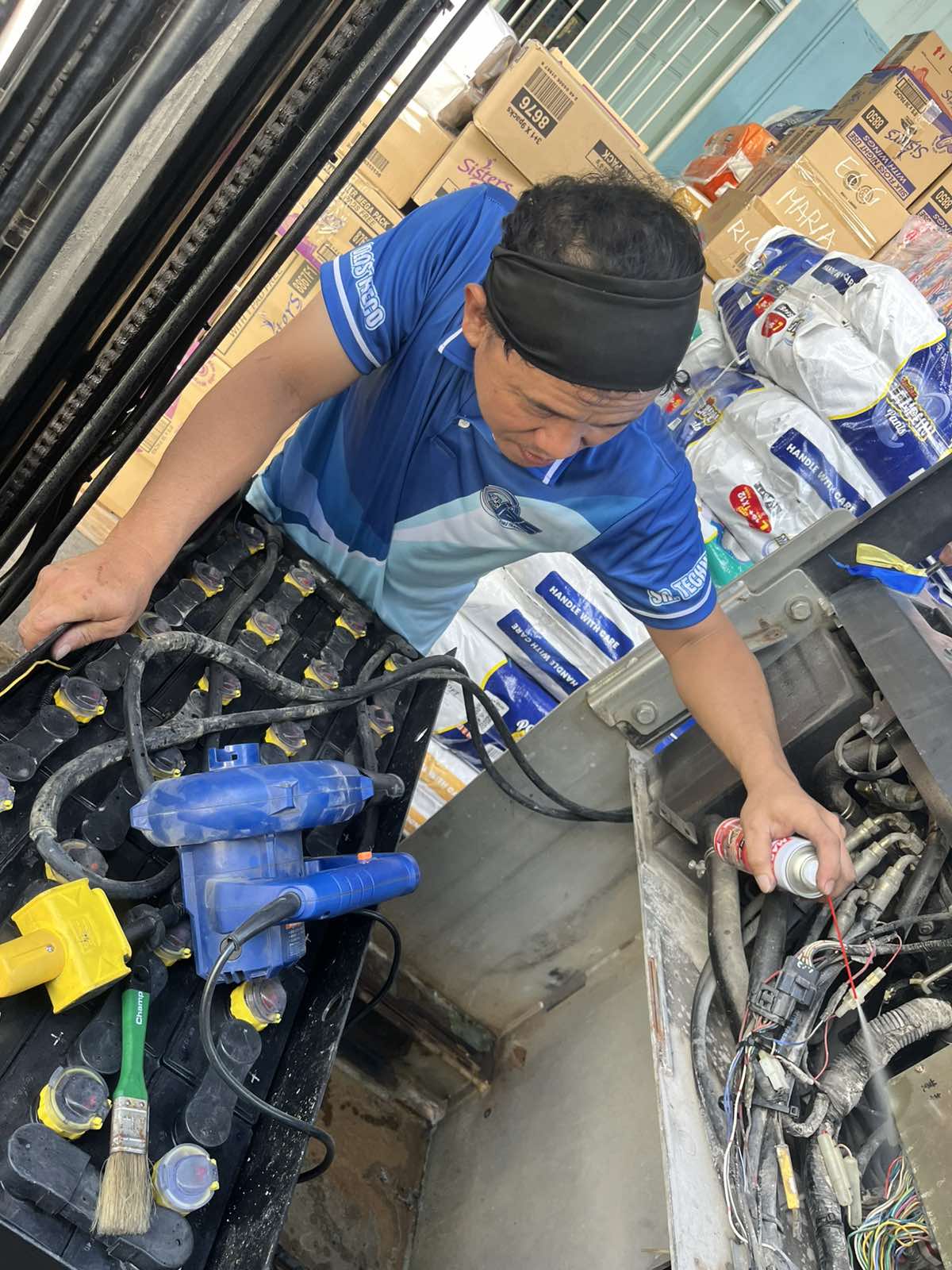 J.A.S technician servicing forklift batteries